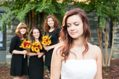 bride in front of three bridesmaids.